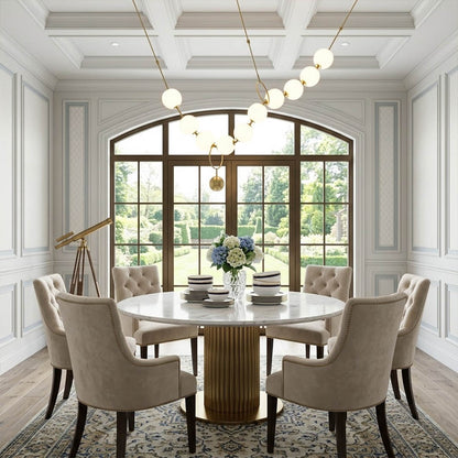 Cascadia horizontal chandelier above long dining table pearl globes warm glow elegant interior