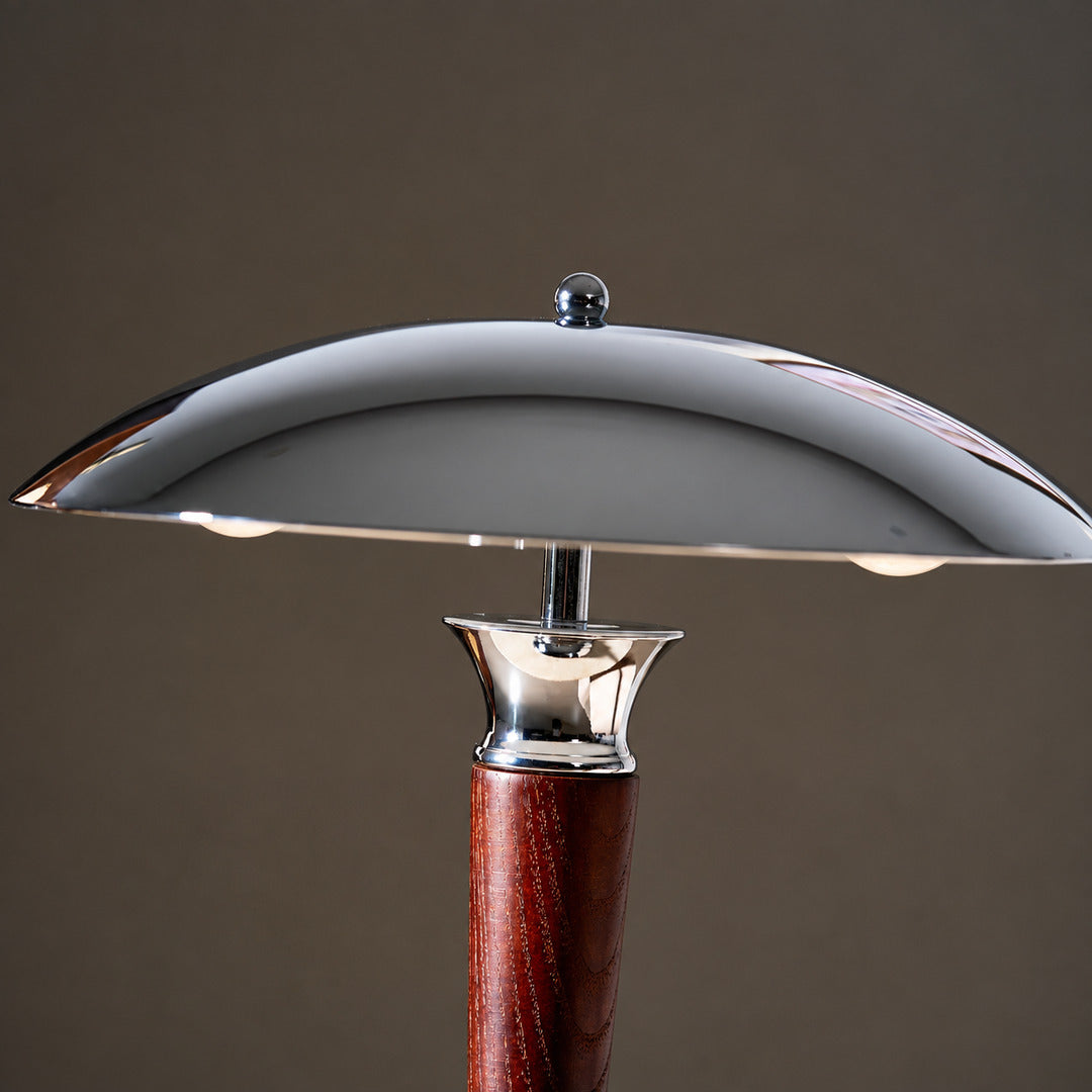 Close-up of the polished chrome helmet-shaped dome shade of the Casco table lamp