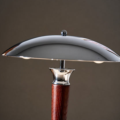 Close-up of the polished chrome helmet-shaped dome shade of the Casco table lamp
