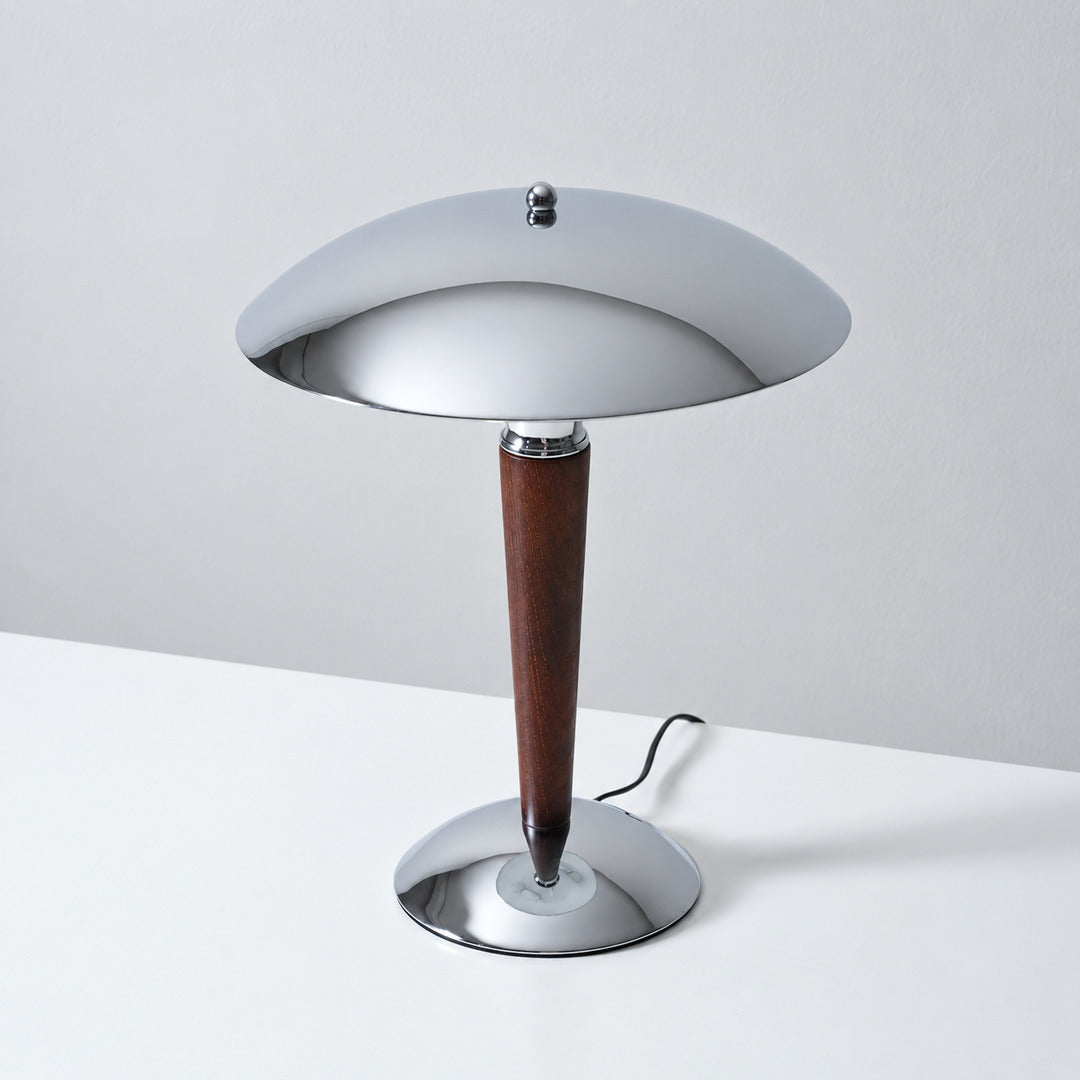 Detail of the turned solid walnut wood stem and chrome base of the Casco table lamp