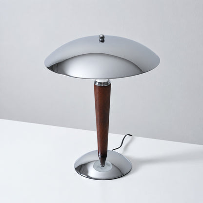 Detail of the turned solid walnut wood stem and chrome base of the Casco table lamp