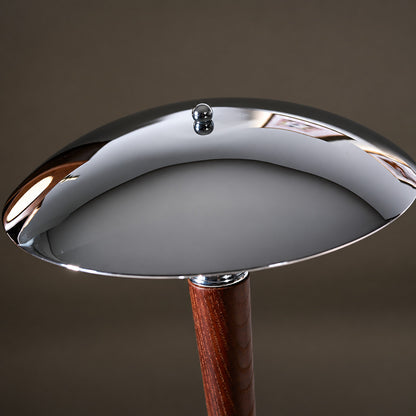 Close-up of the polished chrome helmet-shaped dome shade of the Casco table lamp
