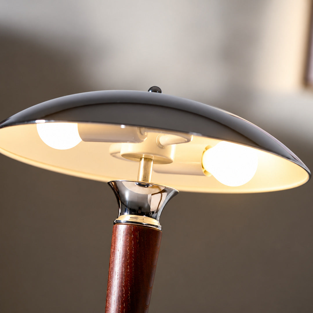 Close-up of the polished chrome helmet-shaped dome shade of the Casco table lamp