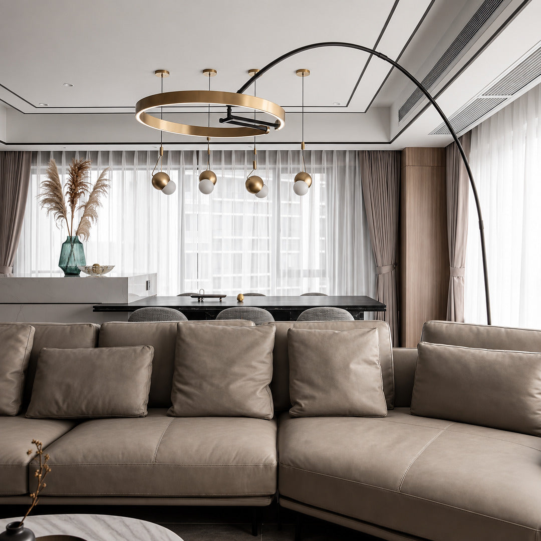 Cerchio halo ring floor lamp standing beside a sofa as a modern sculptural accent in a living room