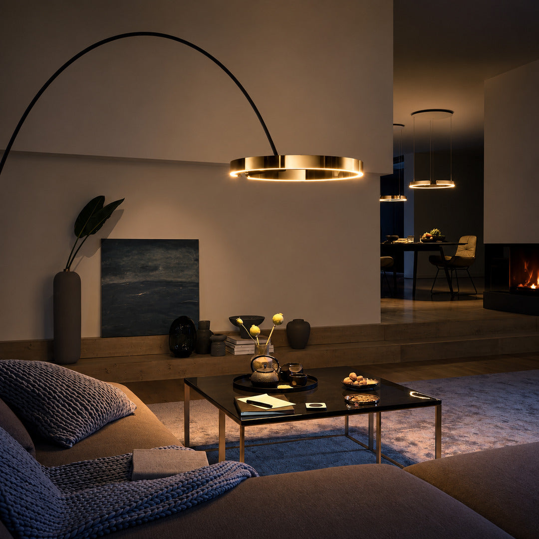 Cerchio halo ring floor lamp standing beside a sofa as a modern sculptural accent in a living room