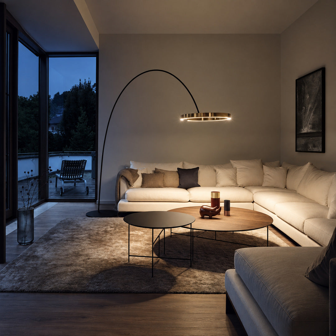 Cerchio halo ring floor lamp standing beside a sofa as a modern sculptural accent in a living room