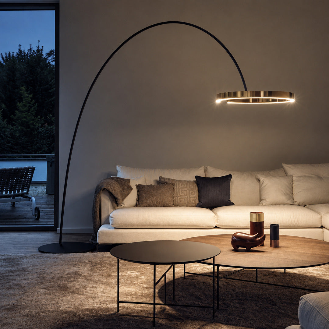 Cerchio halo ring floor lamp standing beside a sofa as a modern sculptural accent in a living room