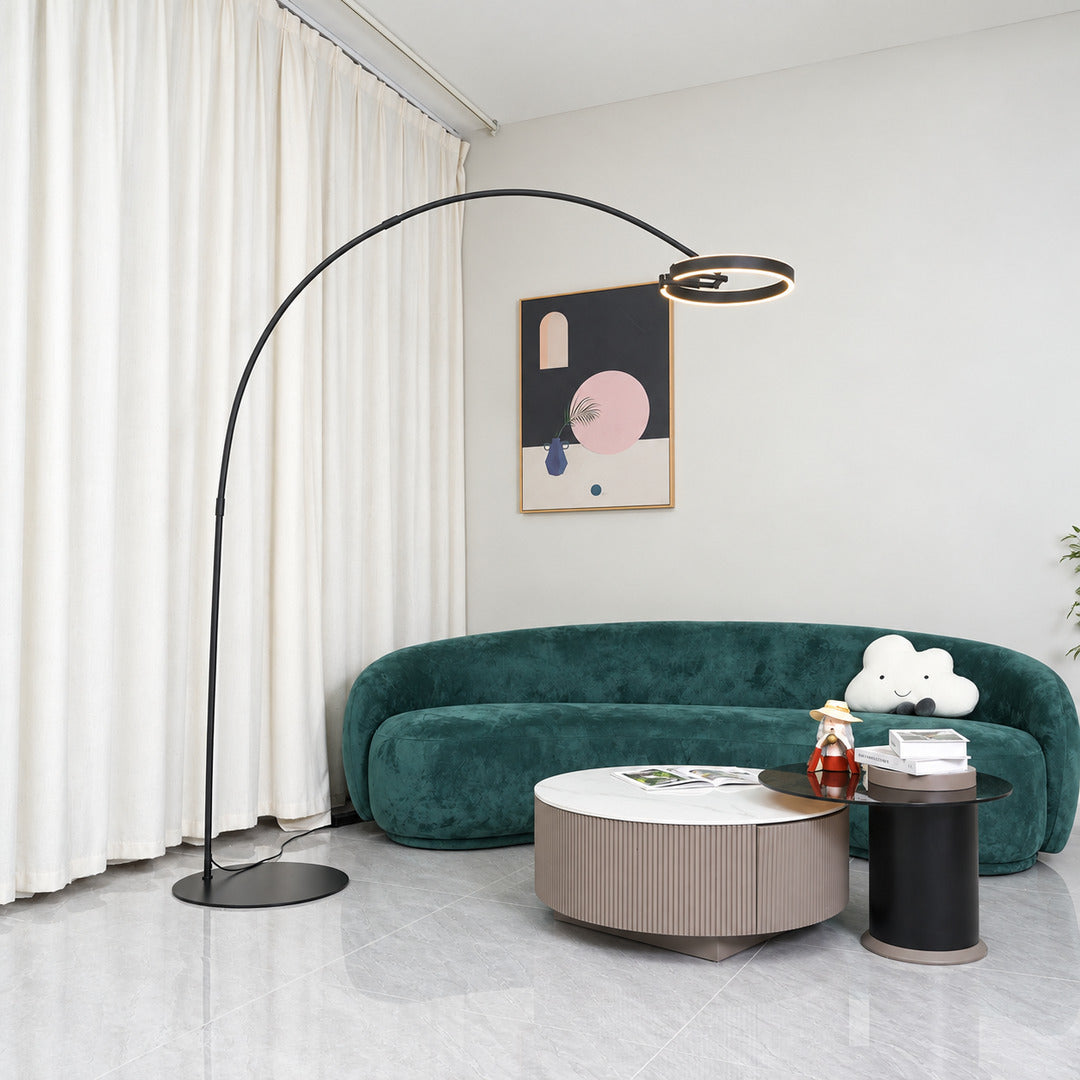Cerchio halo ring floor lamp standing beside a sofa as a modern sculptural accent in a living room
