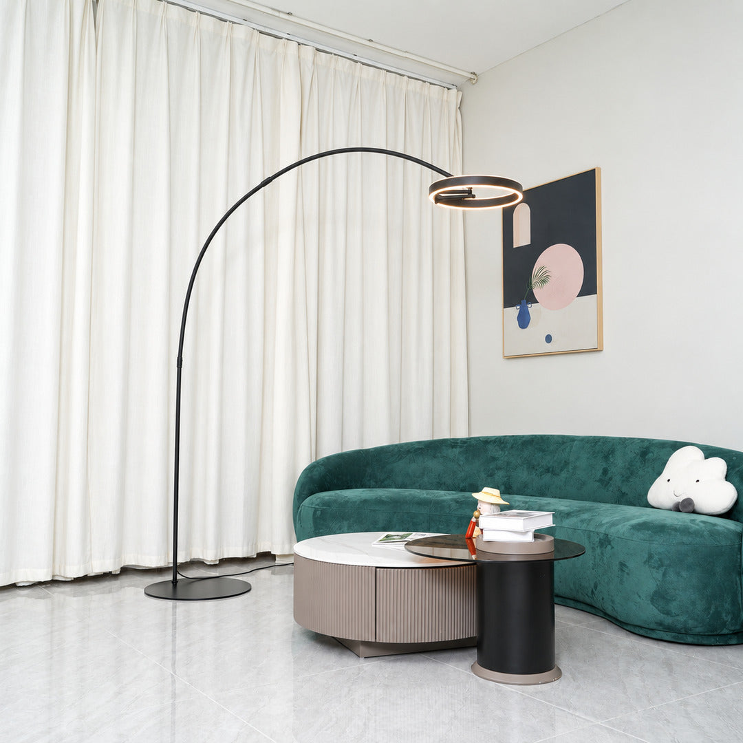 Cerchio halo ring floor lamp standing beside a sofa as a modern sculptural accent in a living room