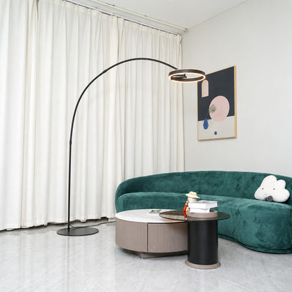 Cerchio halo ring floor lamp standing beside a sofa as a modern sculptural accent in a living room