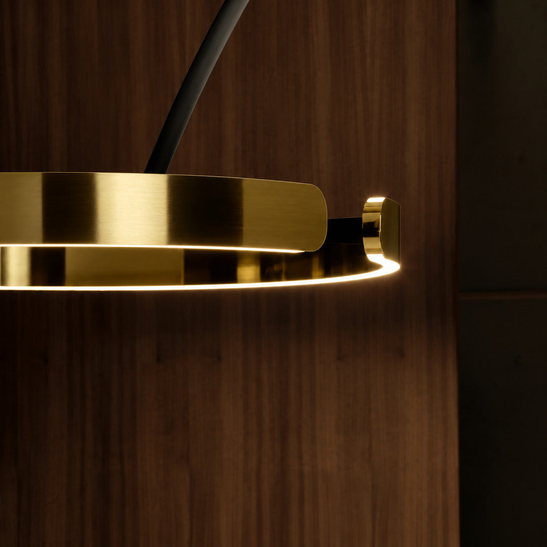Close-up of the floating illuminated ring head of the Cerchio floor lamp glowing warm