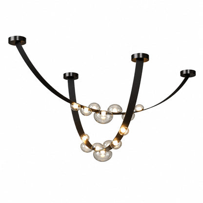 Cinghia leather arc chandelier with a long metal arc wrapped in leather and glowing glass orbs over a dining table