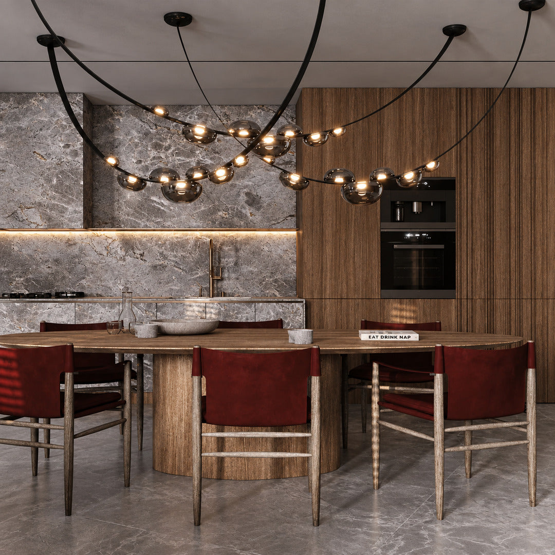 Cinghia leather arc chandelier casting a warm glow over a long dining table