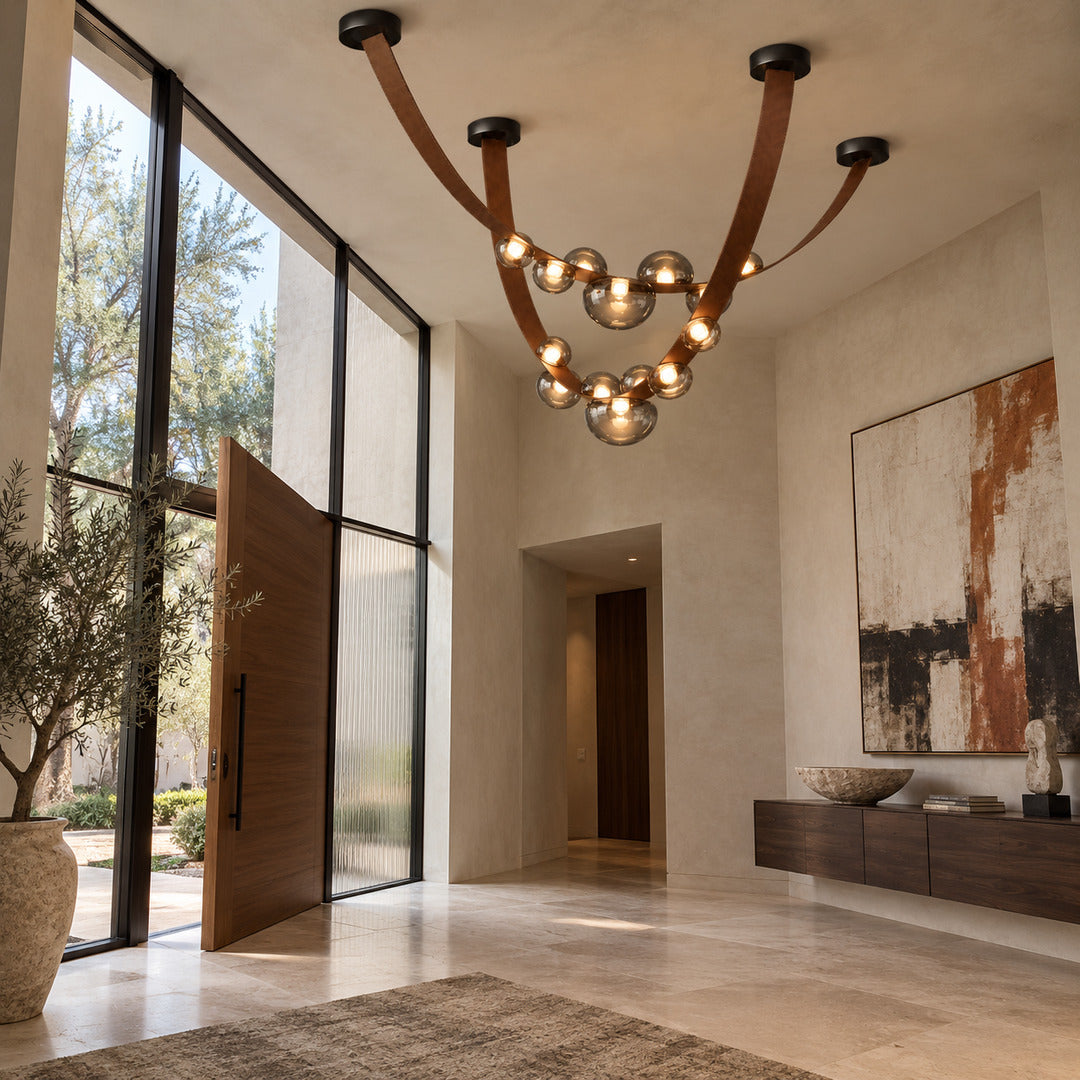 Cinghia leather arc chandelier welcoming guests with a warm glow in an entryway