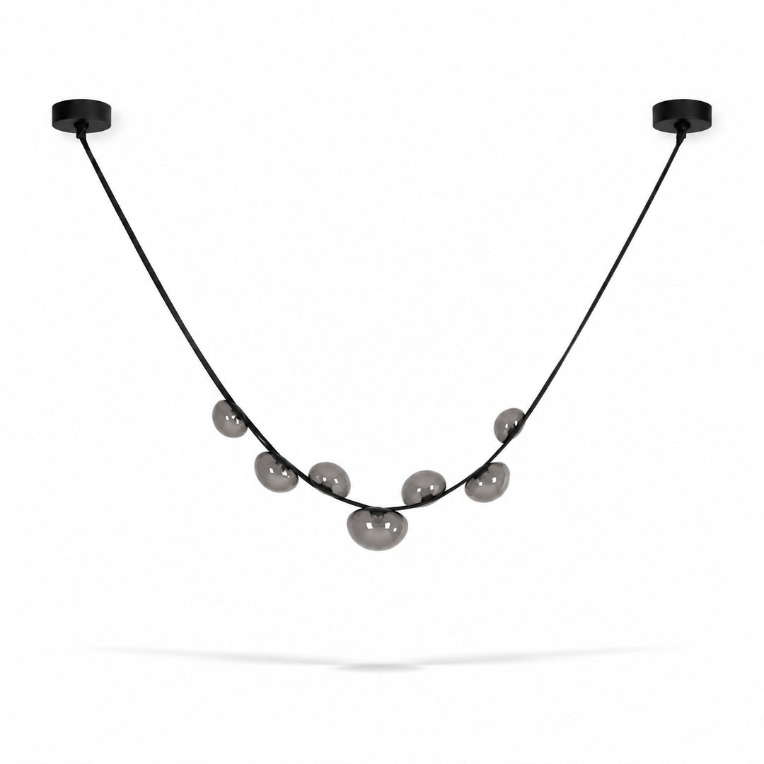 Single strip black and grey Cinghia leather arc chandelier over a dining table