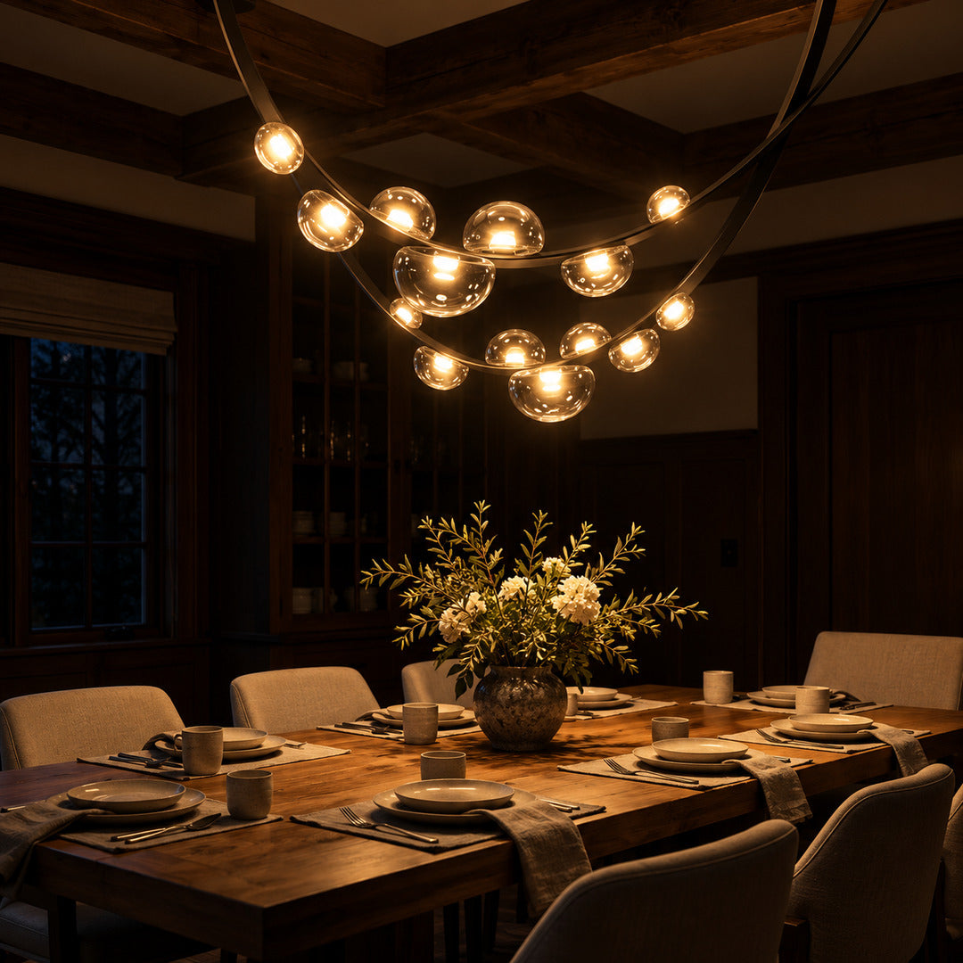 Cinghia leather arc chandelier casting a warm glow over a long dining table