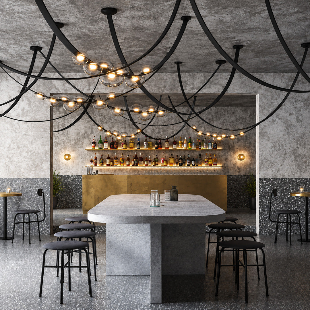 Cinghia leather arc chandeliers over long tables in an upscale restaurant