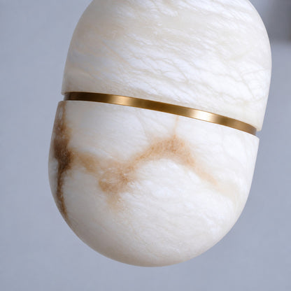 Close-up of the natural alabaster bowl shade on the Ciotola pendant lit softly from within