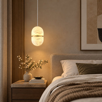 Single Ciotola alabaster pendant hanging beside a modern bedroom nightstand