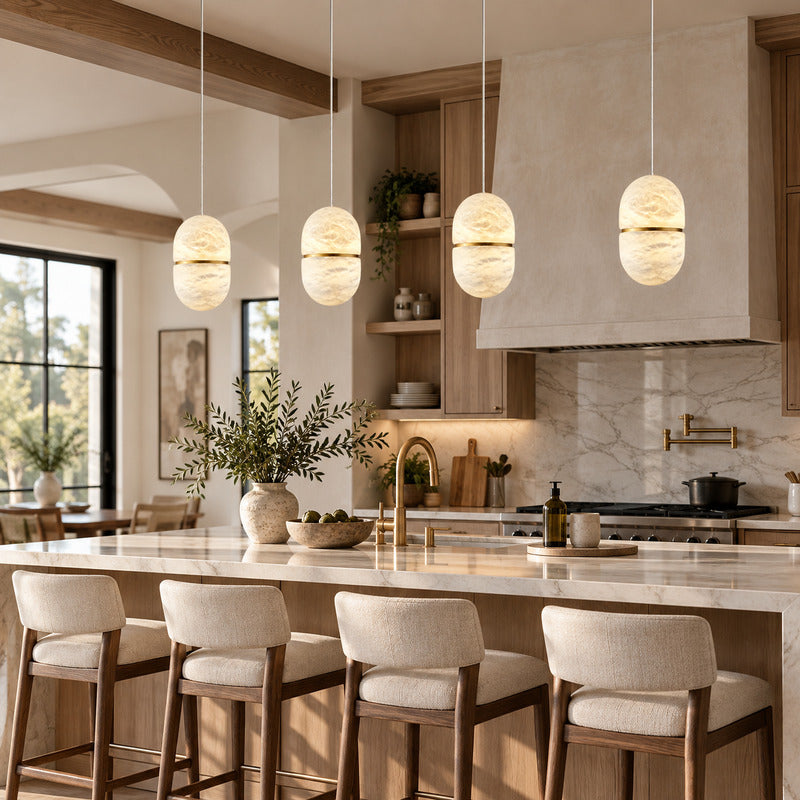 Row of single Ciotola alabaster pendants suspended over a modern kitchen island