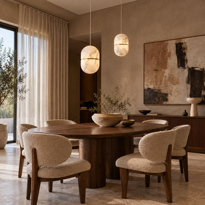 Ciotola alabaster pendant casting a warm glow over an elegant dining table