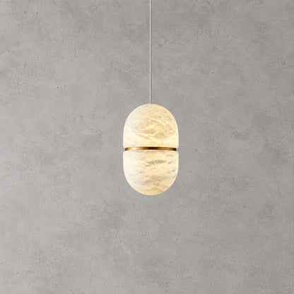 Larger single Ciotola alabaster pendant centered over a kitchen counter