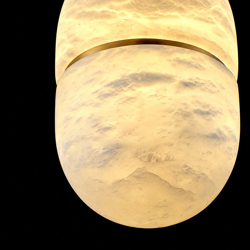 Warm glow diffusing softly through the alabaster bowl of the Ciotola pendant