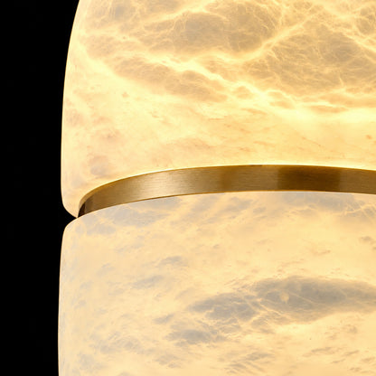 Warm glow diffusing softly through the alabaster bowl of the Ciotola pendant