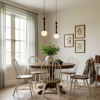Colette Wood color pendant above French country dining room vintage elegance white walls warm Edison glow Provence interior