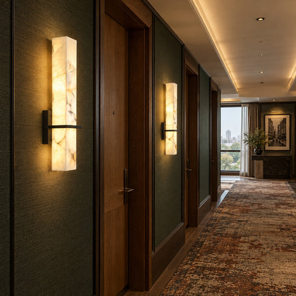 Row of Colonna alabaster wall sconces lighting a long hallway