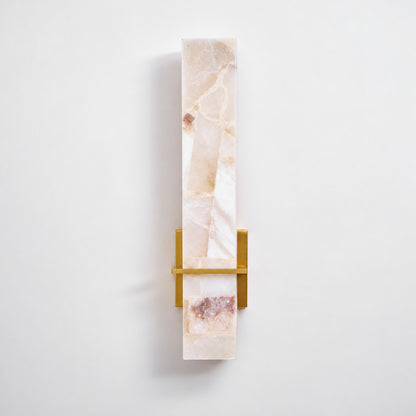 Close-up of natural veining glowing through the alabaster cylinder of the Colonna sconce