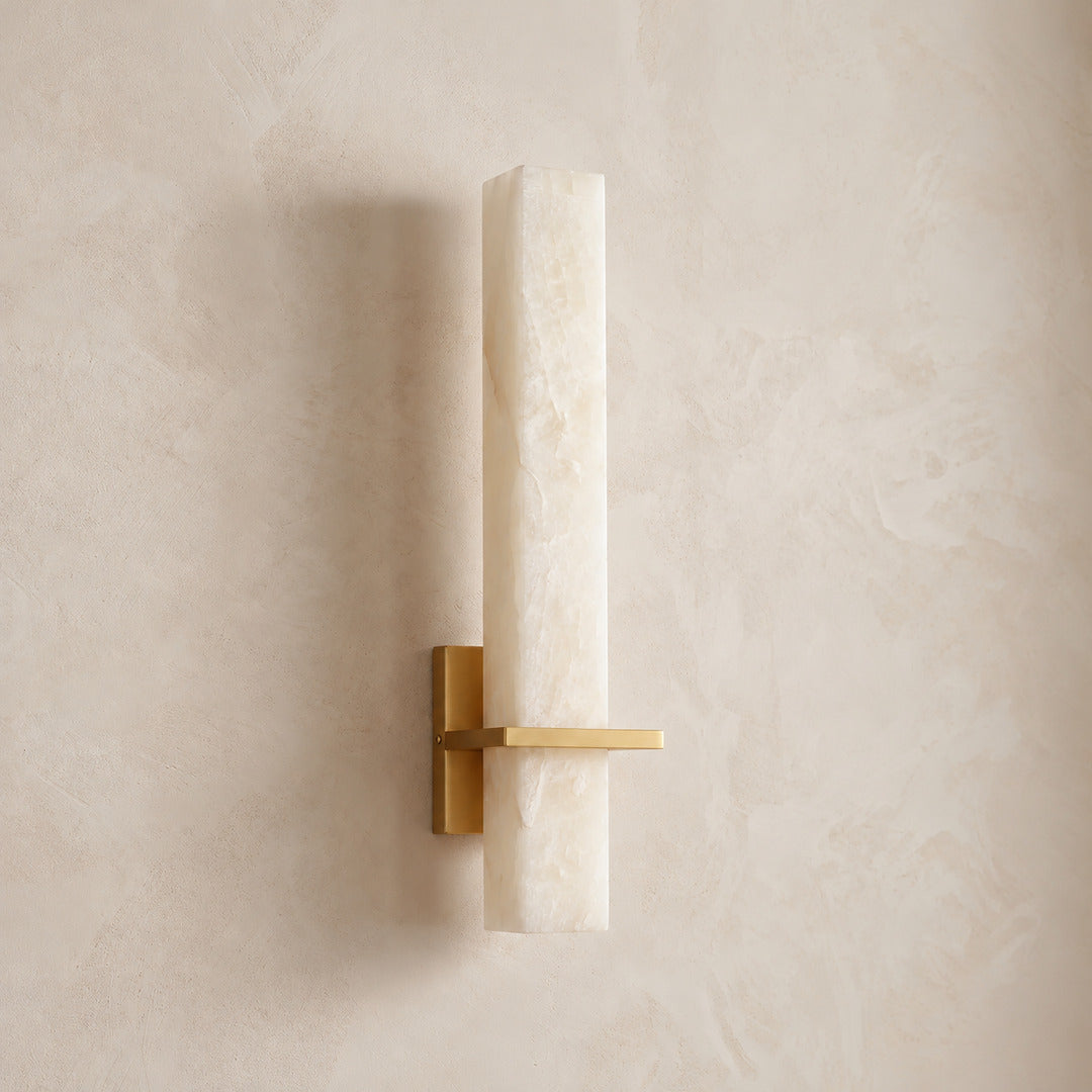 Colonna alabaster cylinder wall sconce shown lit and unlit side by side