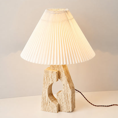 Colonna travertine table lamp illuminated warm elegant glow natural travertine stone fabric shade cozy white background