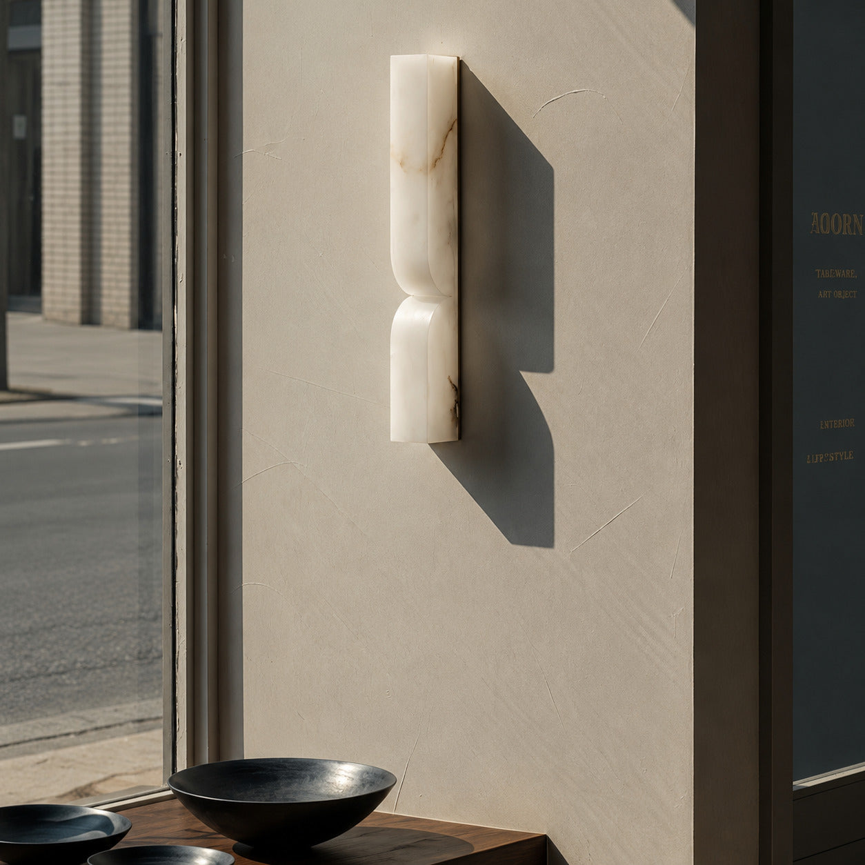 Contatto alabaster wall sconce boutique hotel corridor carved natural stone quiet luxury hospitality American commercial interior