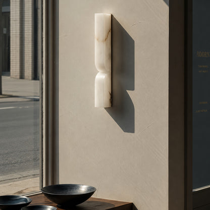 Contatto alabaster wall sconce boutique hotel corridor carved natural stone quiet luxury hospitality American commercial interior