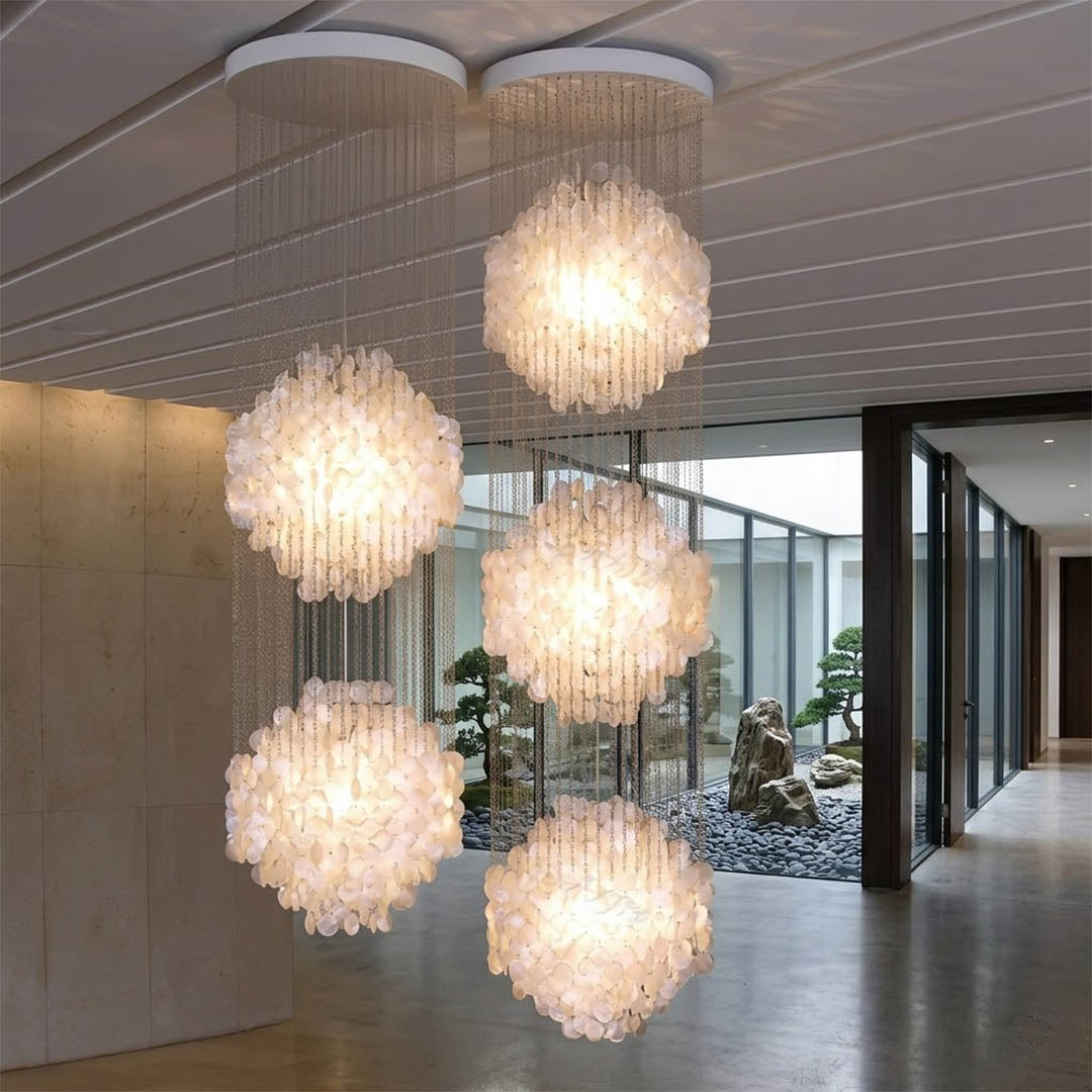 Coralia FUN tall style staircase shell chandelier oceanfront modern mansion grand entry ocean view glass walls Coastal Mid Century designer mansion scale warm glow lifestyle interior