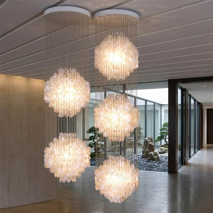 Coralia FUN tall style staircase shell chandelier oceanfront modern mansion grand entry ocean view glass walls Coastal Mid Century designer mansion scale warm glow lifestyle interior