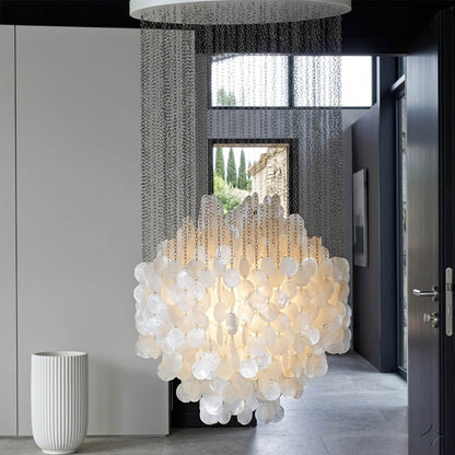 Coralia FUN tall style staircase shell chandelier oceanfront modern mansion grand entry ocean view glass walls Coastal Mid Century designer mansion scale warm glow lifestyle interior
