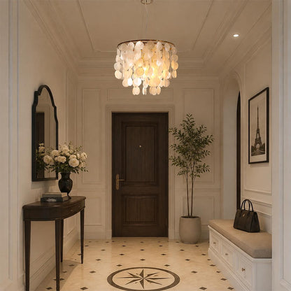 Coastal style Coraline capiz shell wind chime chandelier lighting up a rustic entryway foyer