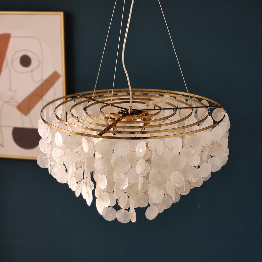 Coraline capiz shell wind chime chandelier displayed against a dark backdrop showcasing cascading shell tiers