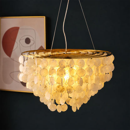 Warm ambient glow emitted through natural capiz shell layers on the Coraline wind chime chandelier