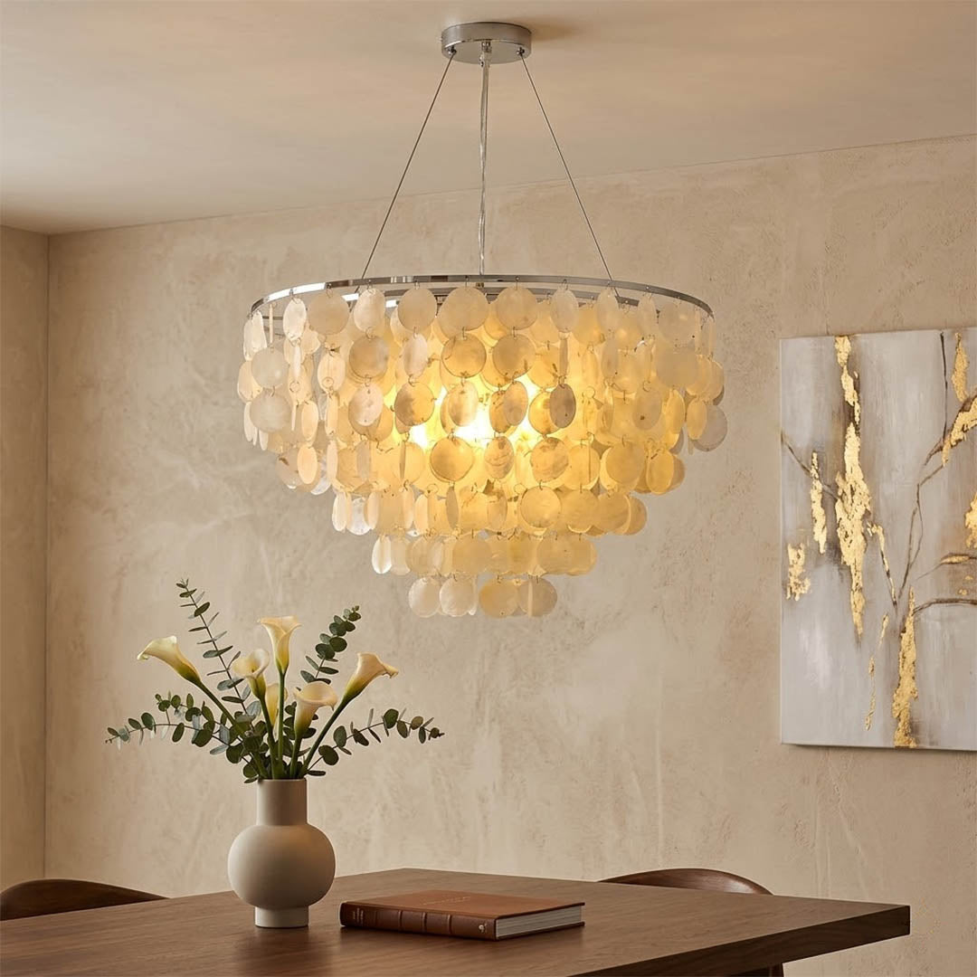 Coraline Capiz shell wind chime chandelier beach house dining room Coastal Hampton white wood interior warm glow natural lifestyle