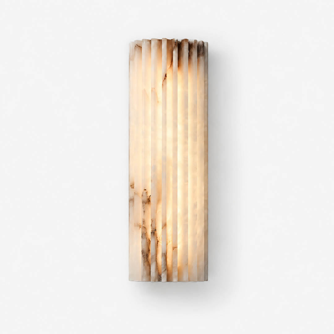 Costa ribbed alabaster wall light illuminated warm glow translucent natural stone ribbed white organic soft radiance white background