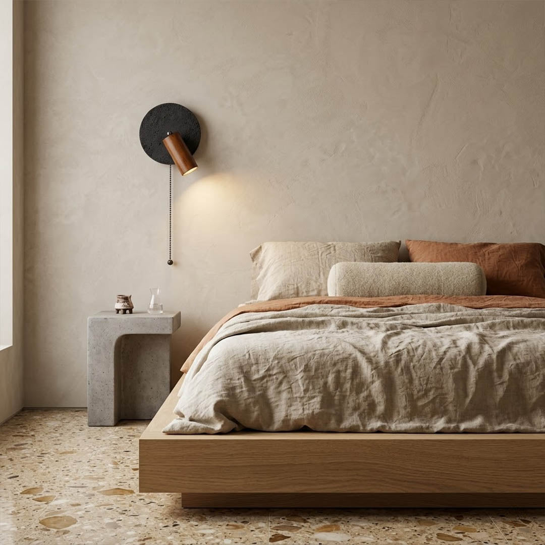 Cove travertine wall sconce mounted beside bed bedroom warm light walnut wood interior