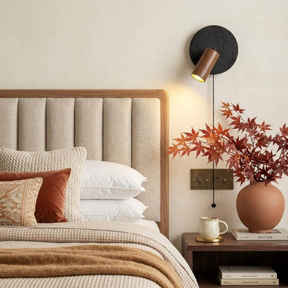 Cove travertine wall sconce mounted beside bed bedroom warm light walnut wood interior