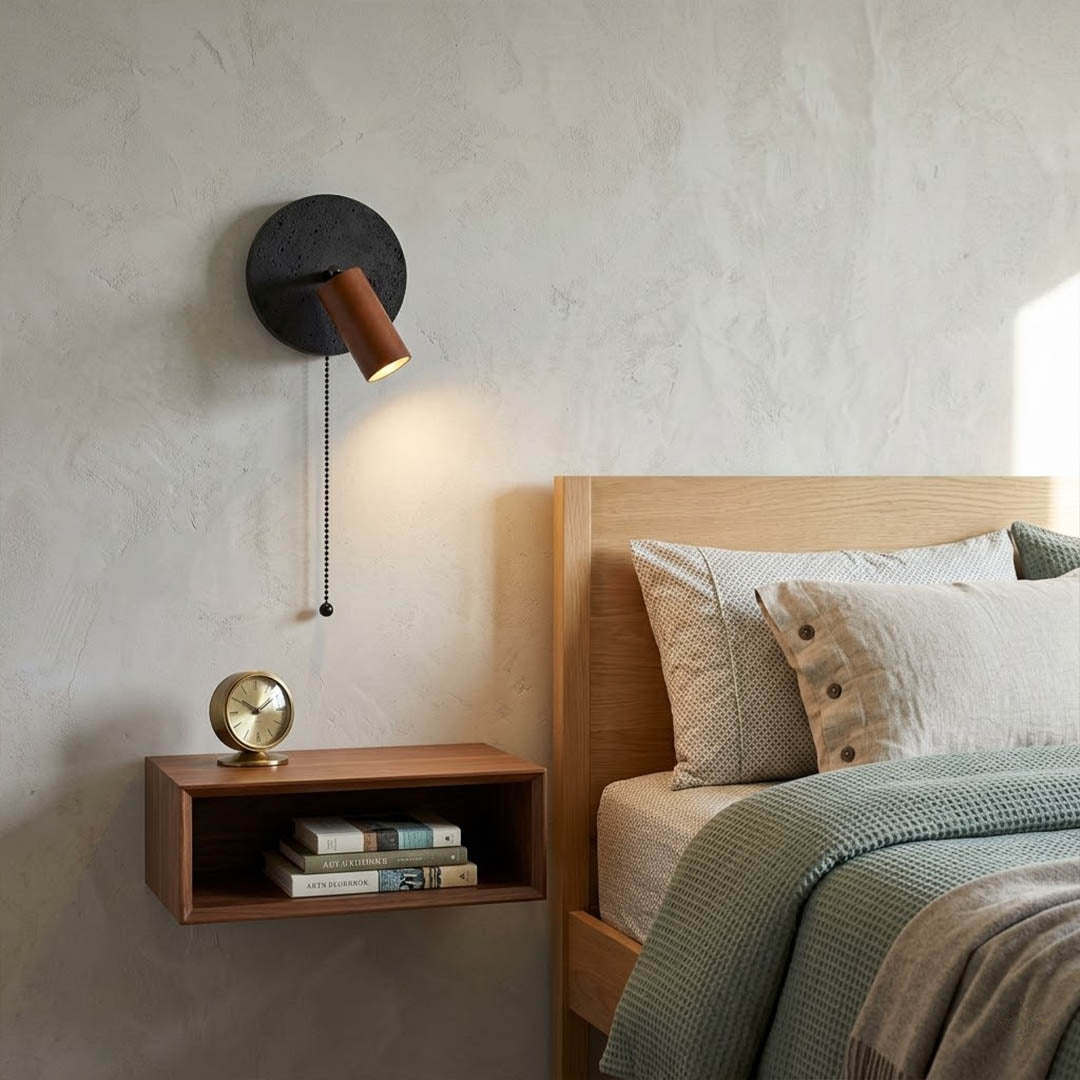 Cove travertine wall sconce mounted beside bed bedroom warm light walnut wood interior