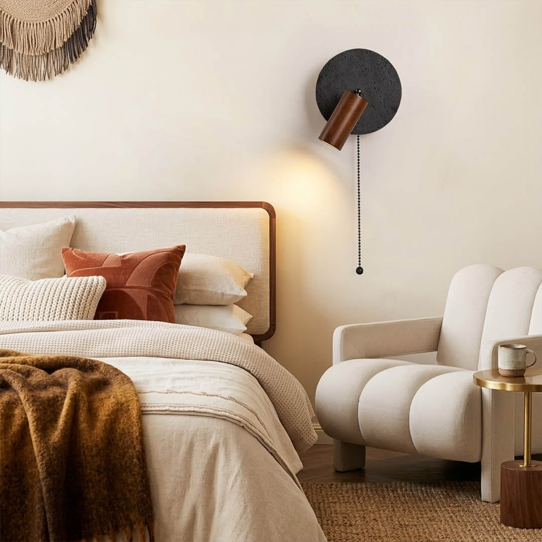 Cove travertine wall sconce mounted beside bed bedroom warm light walnut wood interior