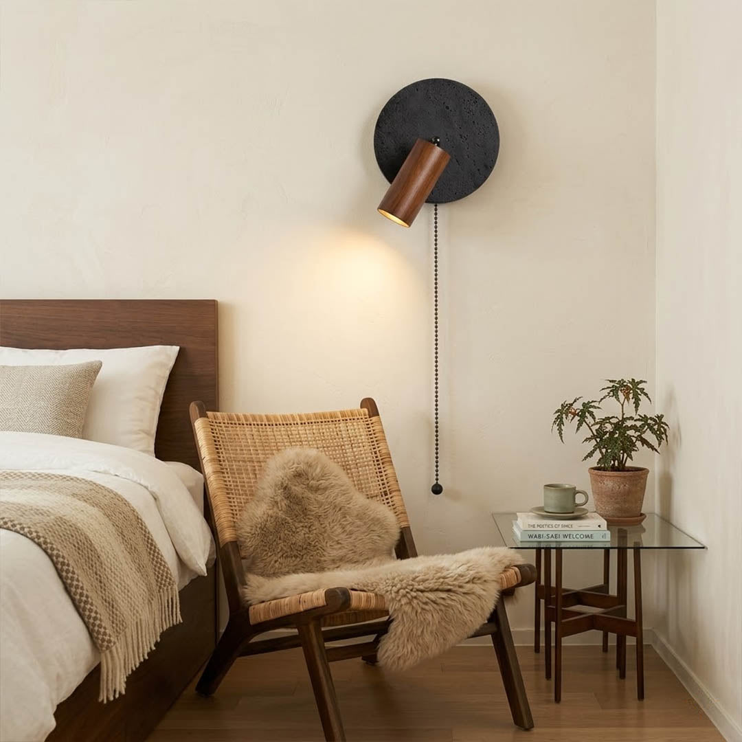 Cove travertine wall sconce mounted beside bed bedroom warm light walnut wood interior