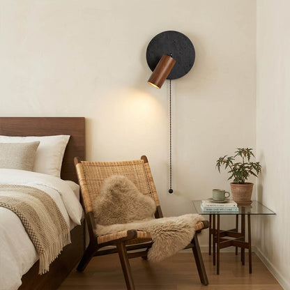 Cove travertine wall sconce mounted beside bed bedroom warm light walnut wood interior