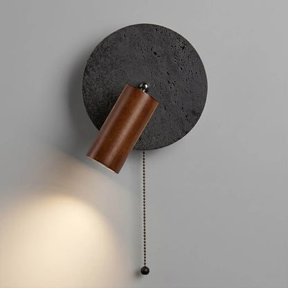 Cove wall sconce black travertine natural stone texture surface detail close up
